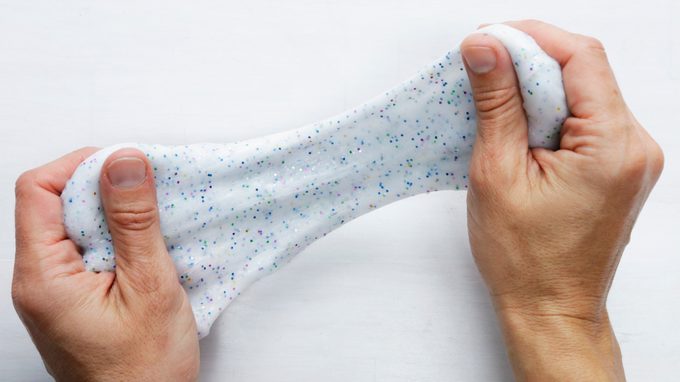 Person stretching homemade slime with their hands