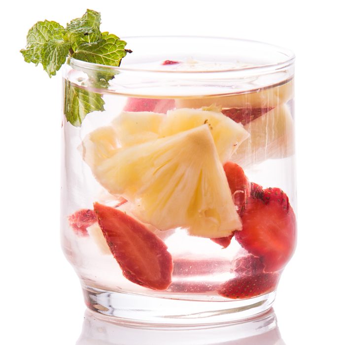 Summer fresh fruit Flavored infused water mix of strawberry and pineapple isolated over white background