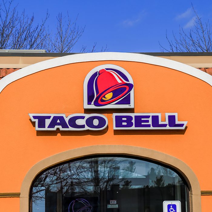 Exterior of Taco Bell fast-food restaurant with sign and logo.