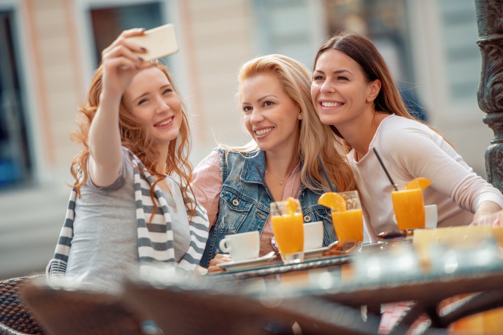 Friends having a great time in cafe.Friends smiling and sitting in a coffee shop, drinking coffee and enjoying together.; Shutterstock ID 1131394877; Job (TFH, TOH, RD, BNB, CWM, CM): TOH Girls Getaway