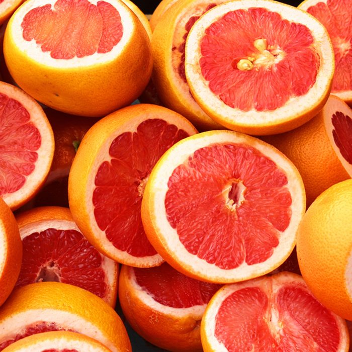Pile of fresh grapefruits on display at street market