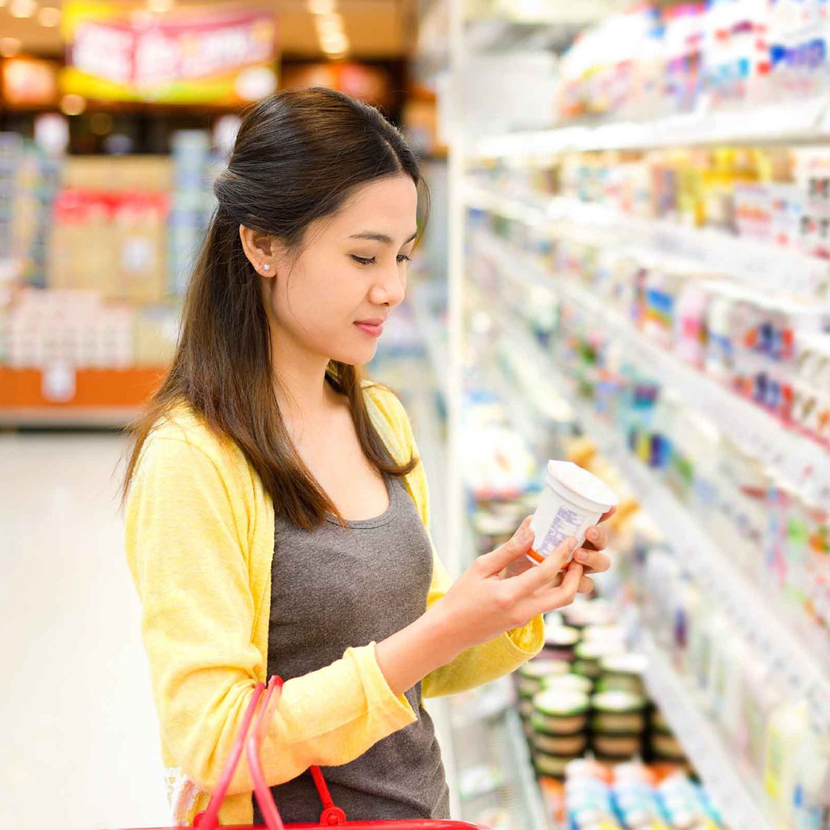 Woman reading product in grocery store