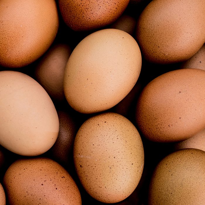 Closeup many of hens eggs with selective focus