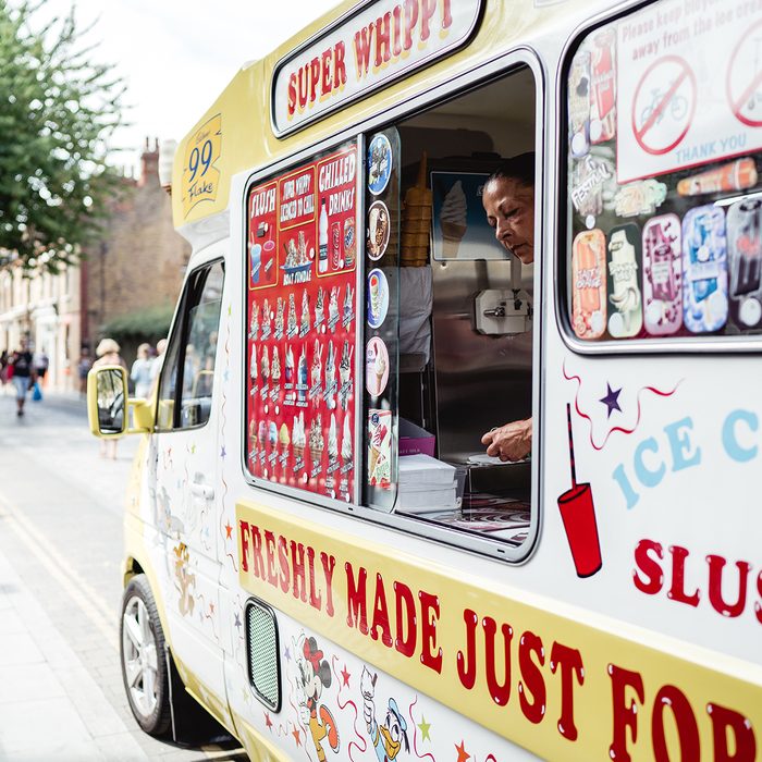 Ice cream truck standing and serving people on the hot weather in London.