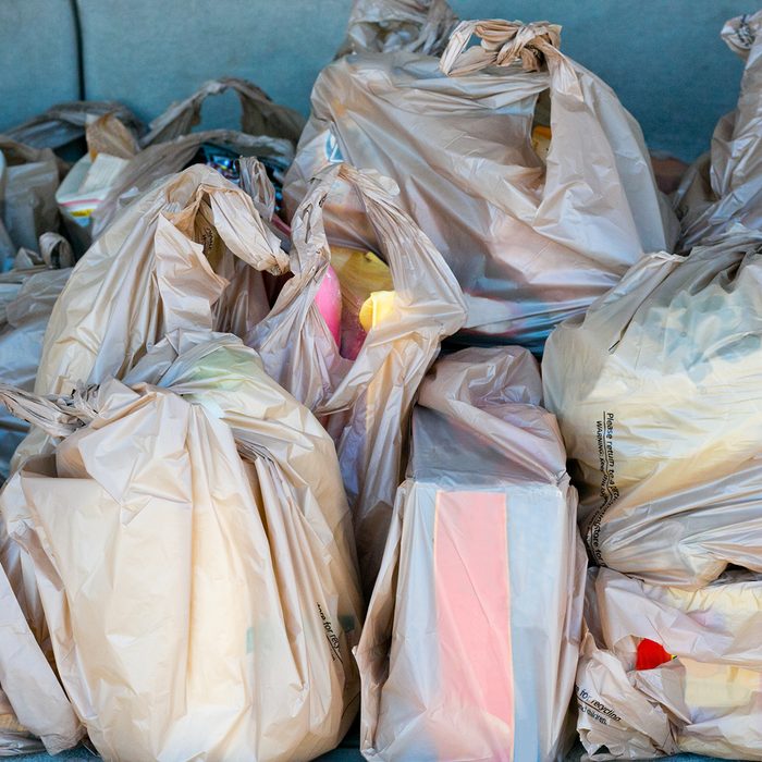 Plastic Bags full of groceries in the trunk