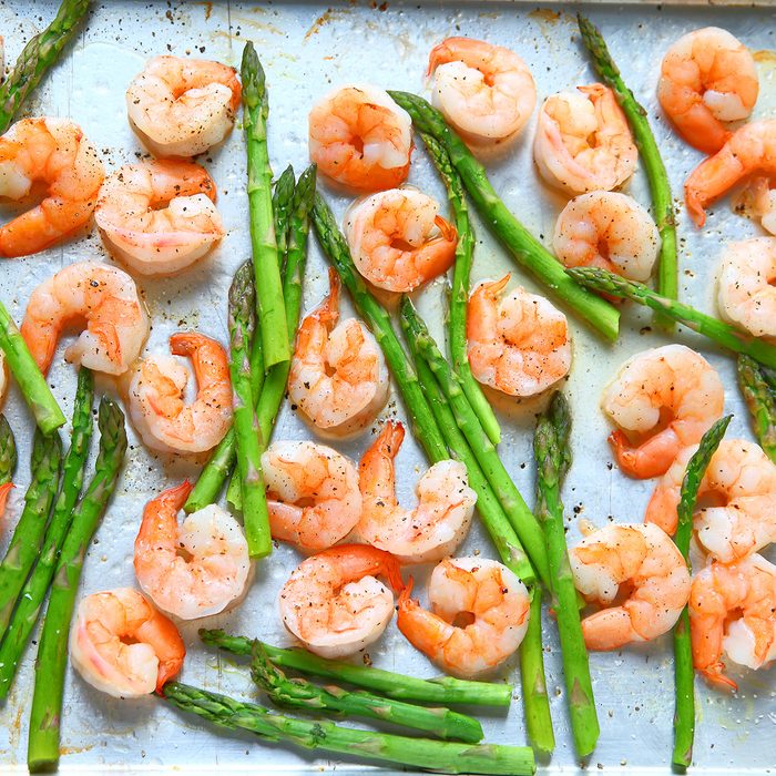 Sheet pan dinner of shrimp and asparagus with olive oil and black pepper