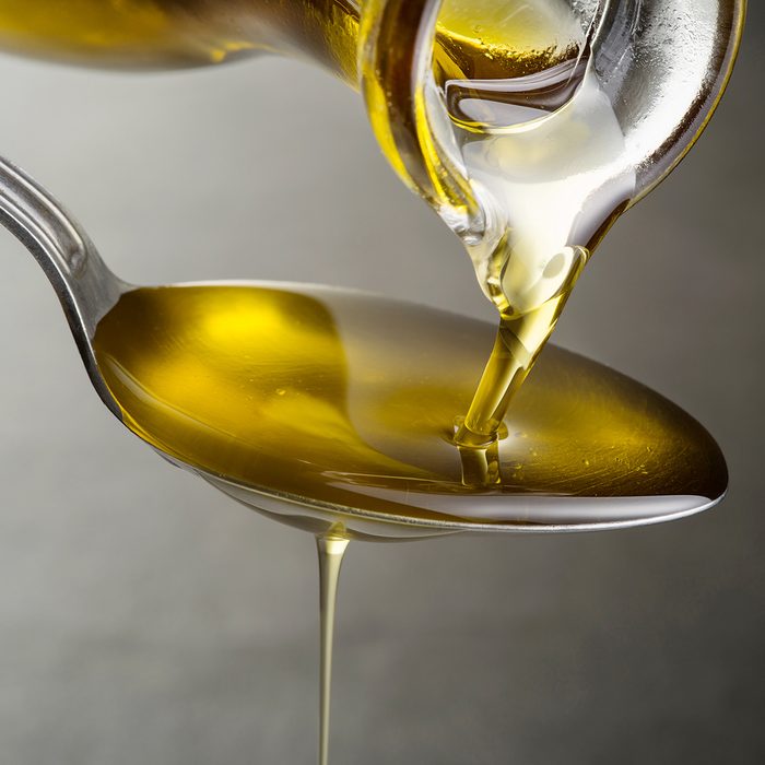 Oil pouring and dripping to the spoon close up; Shutterstock ID 1158168211; Job (TFH, TOH, RD, BNB, CWM, CM): TOH