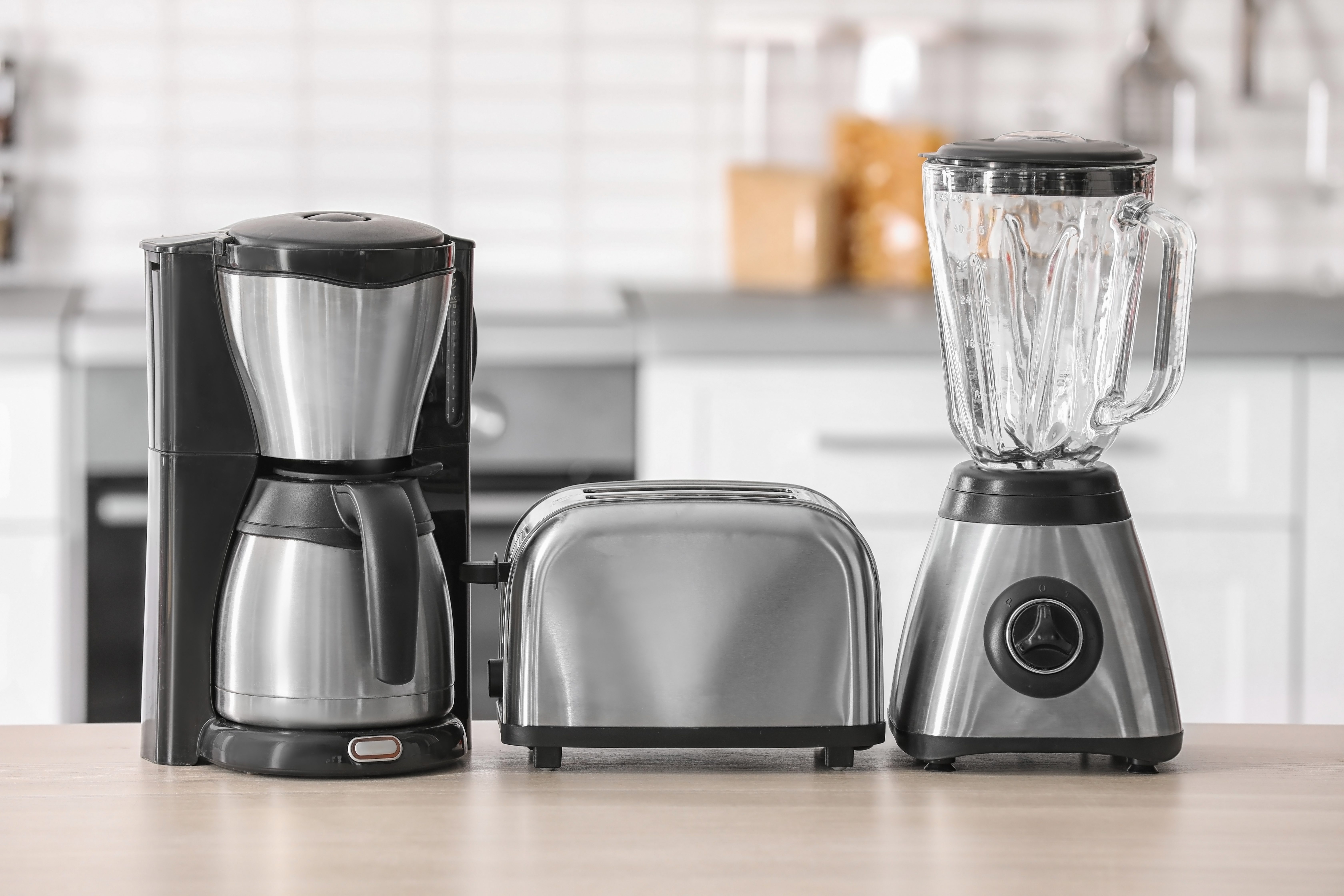 Kitchen appliances on table against blurred background