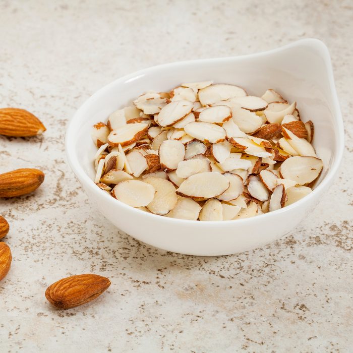 small ceramic bowl of sliced raw almonds