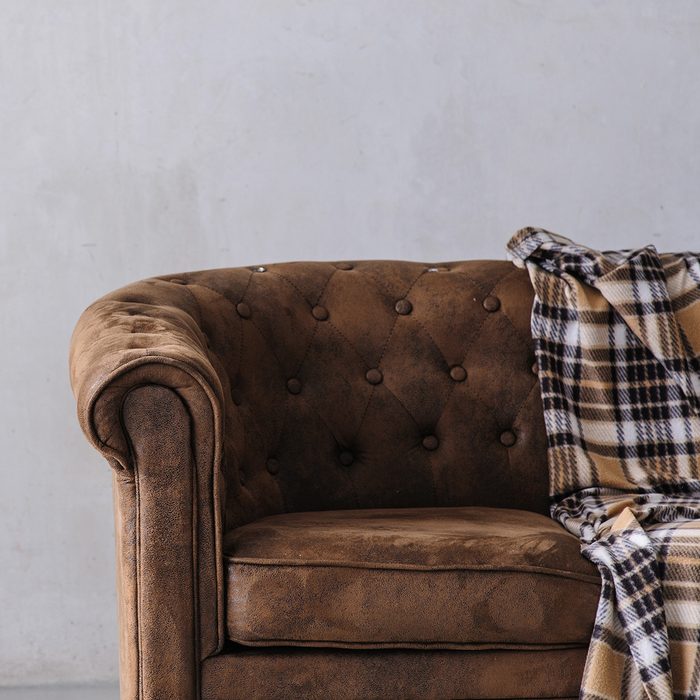 brown leather sofa on light background