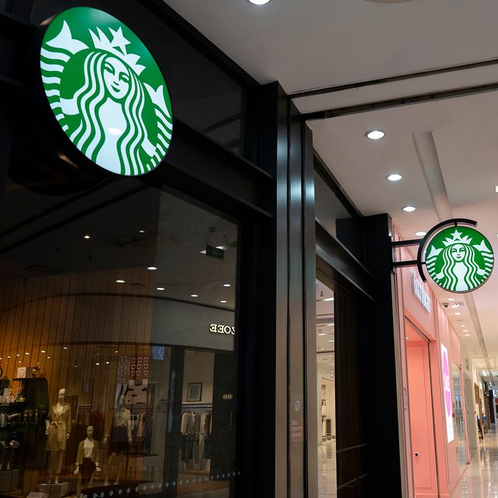 TIANJIN, CHINA - 2020/03/22: A Starbucks coffee store in a shopping mall. After nearly two months of closure by the COVID-19 epidemic situation in China, the Starbucks reopened most of stores in China. Customers are asked to take a temperature check before entering the store, and seated one people one table when dining in the store, otherwise encouraged to take out.