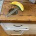 If You See a Wooden Table with a Circular Metal Indent, It's Probably a Hatch Door Table