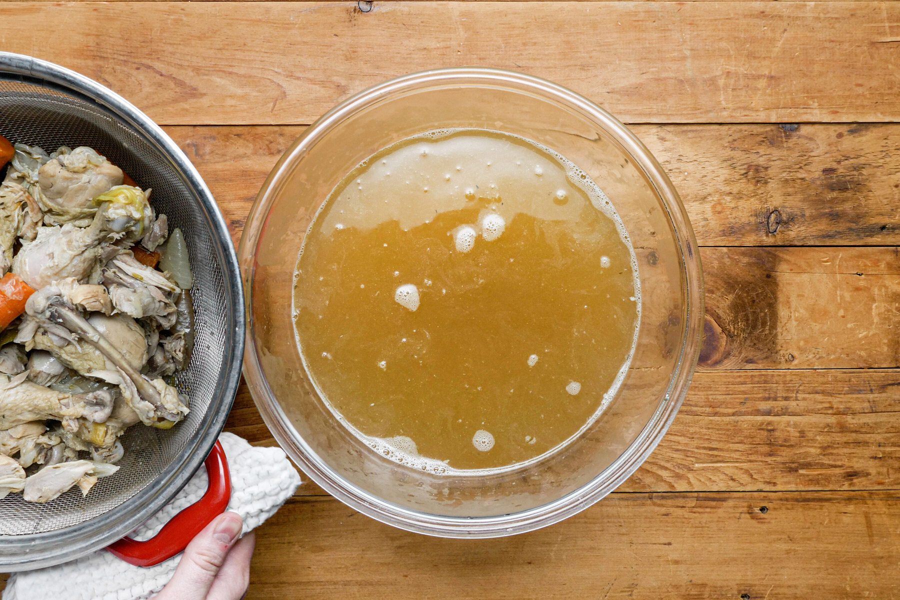 Chicken broth in a glass bowl on the table