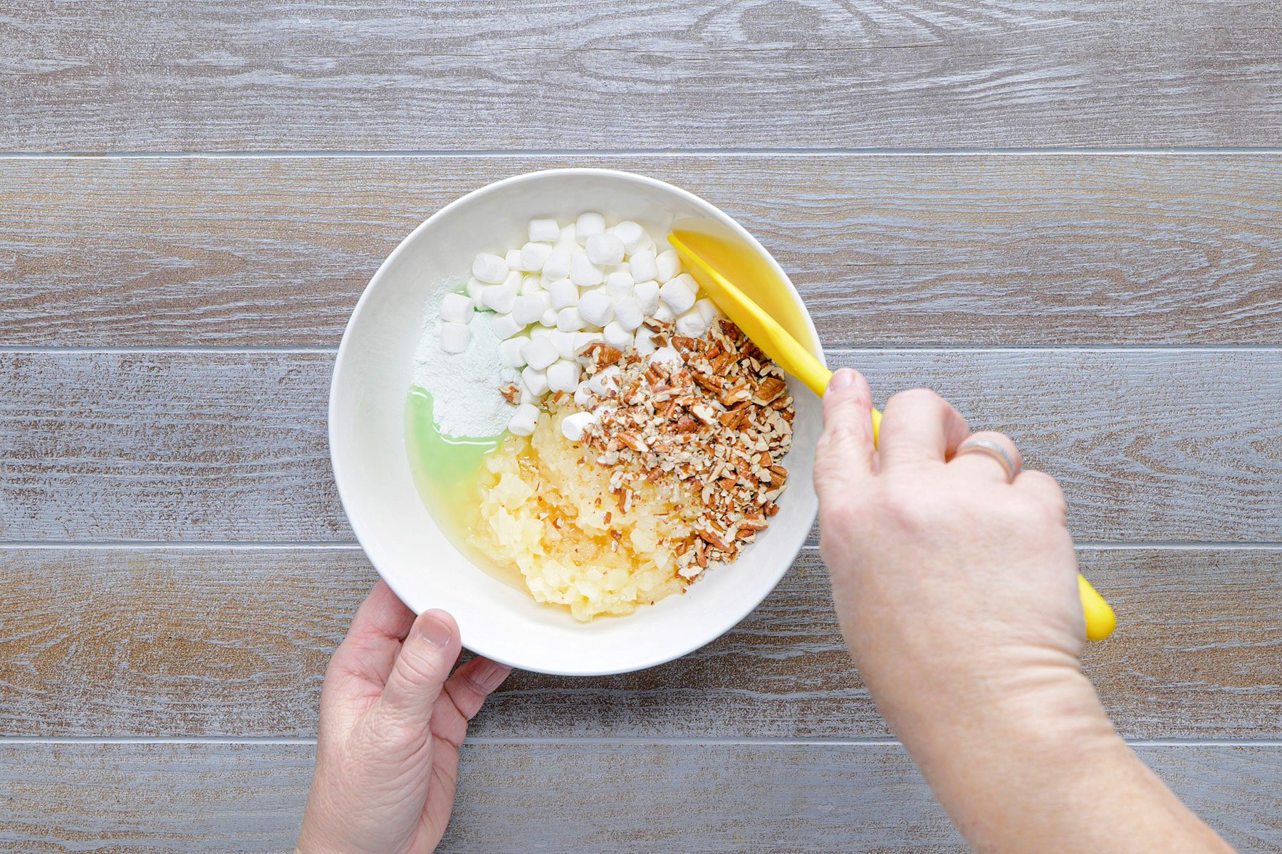 Mixing ingredients in small bowl with spatula