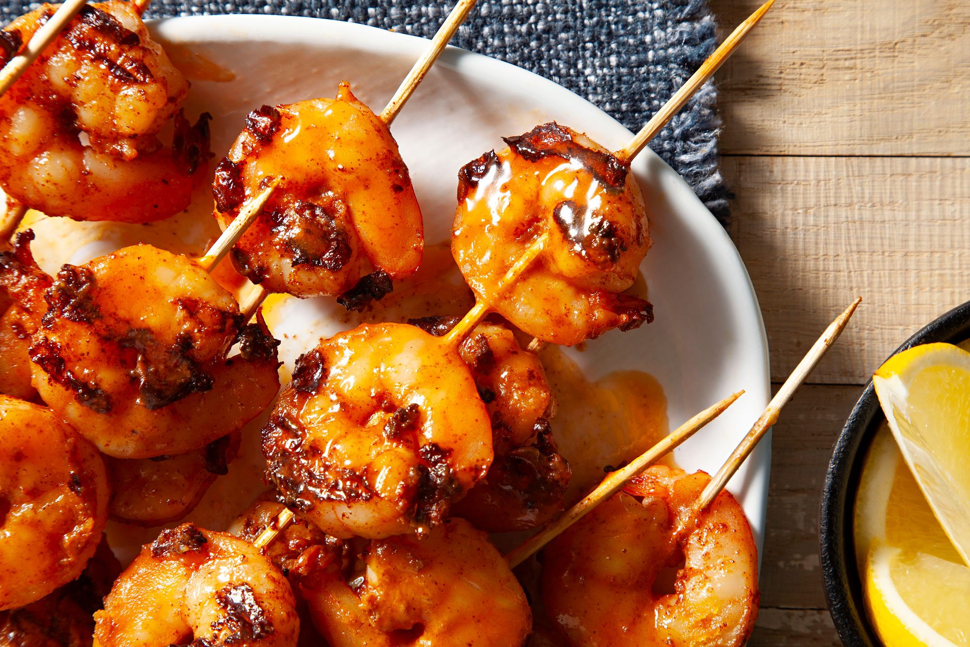 Buttery Grilled shrimp skewers on wooden table