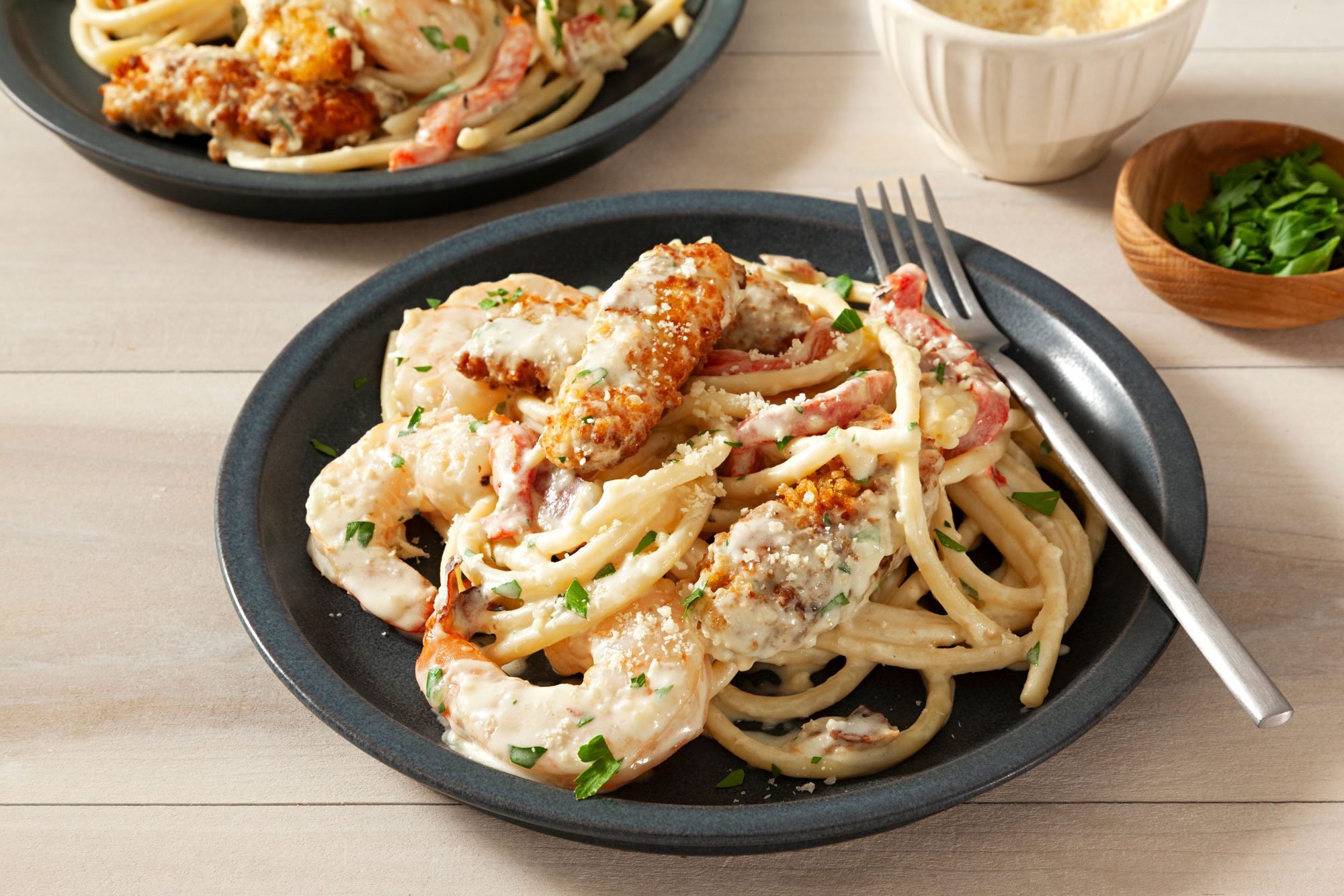 Serve the pasta topped with additional Parmesan cheese and garnish with a sprinkle of chopped parsley