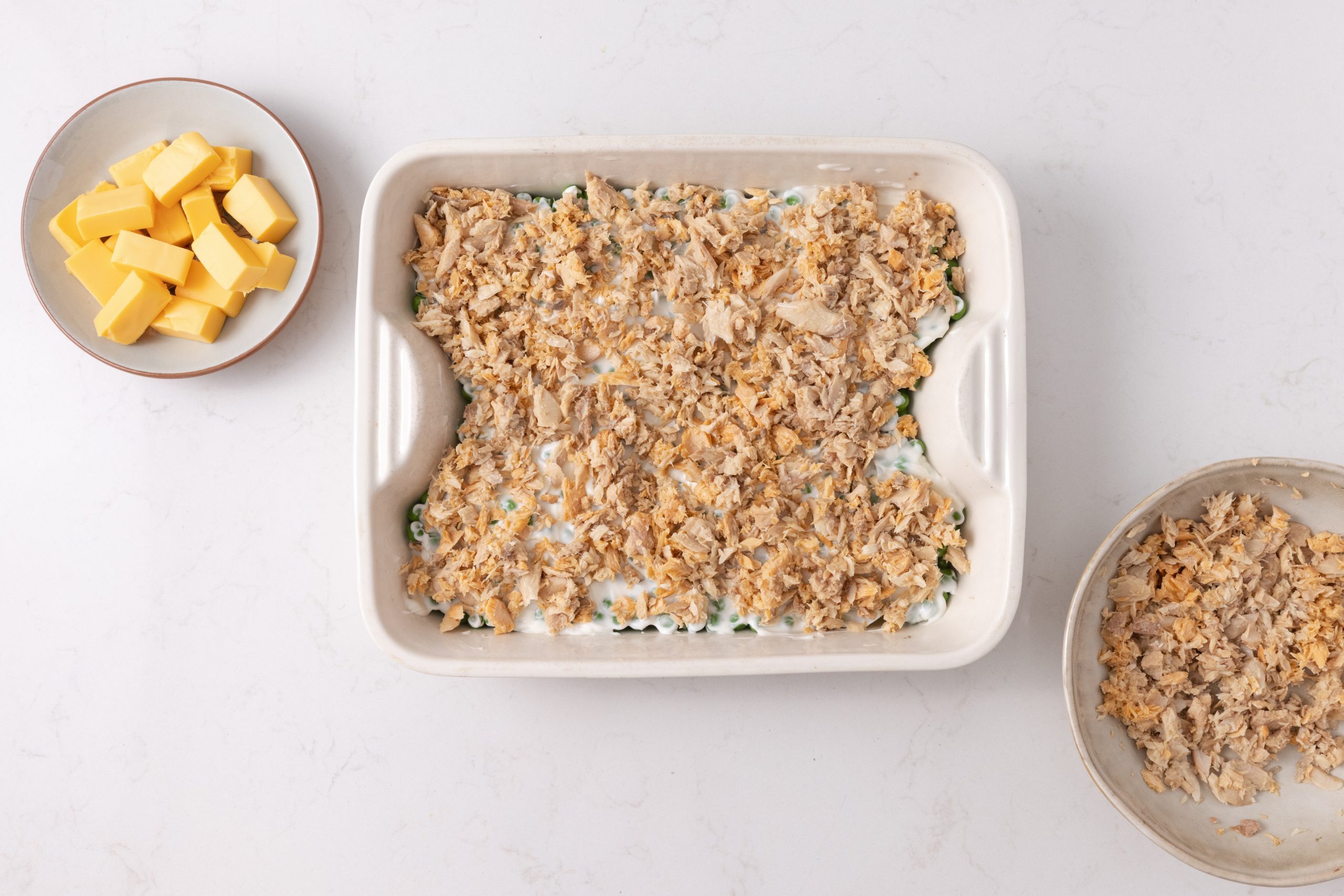 Ingredients being placed in baking dish.
