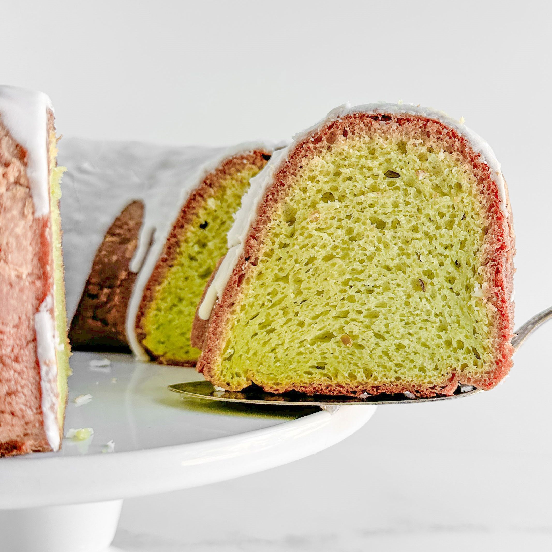 Taste of Home Pistachio Bundt Cake on a vintage server on a white cake stand