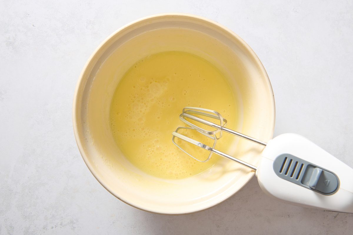 Whisking vanilla pudding in a large bowl