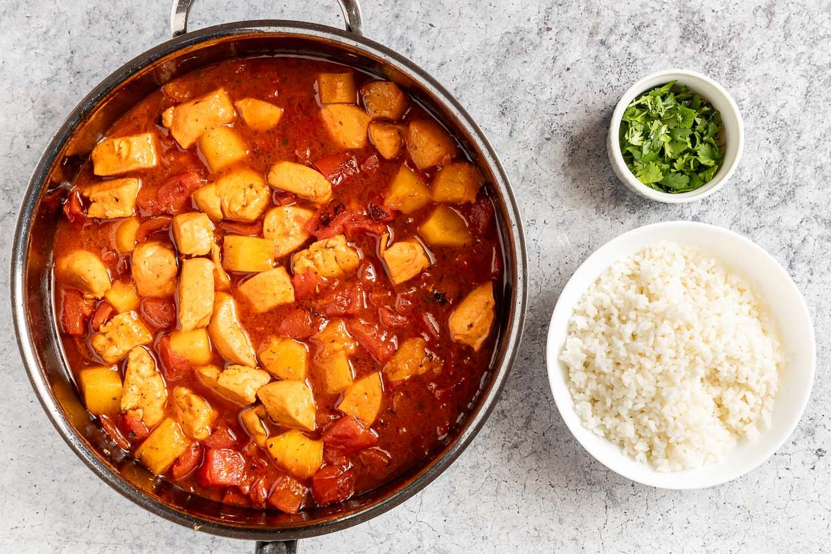 Caribbean Chicken with rice and cilantro on the side.
