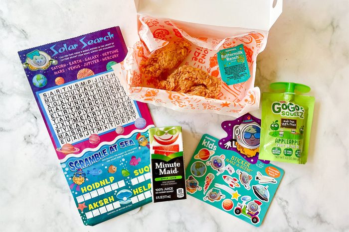 Popeye's Fast Food Kids Meal items arranged on marble kitchen counter