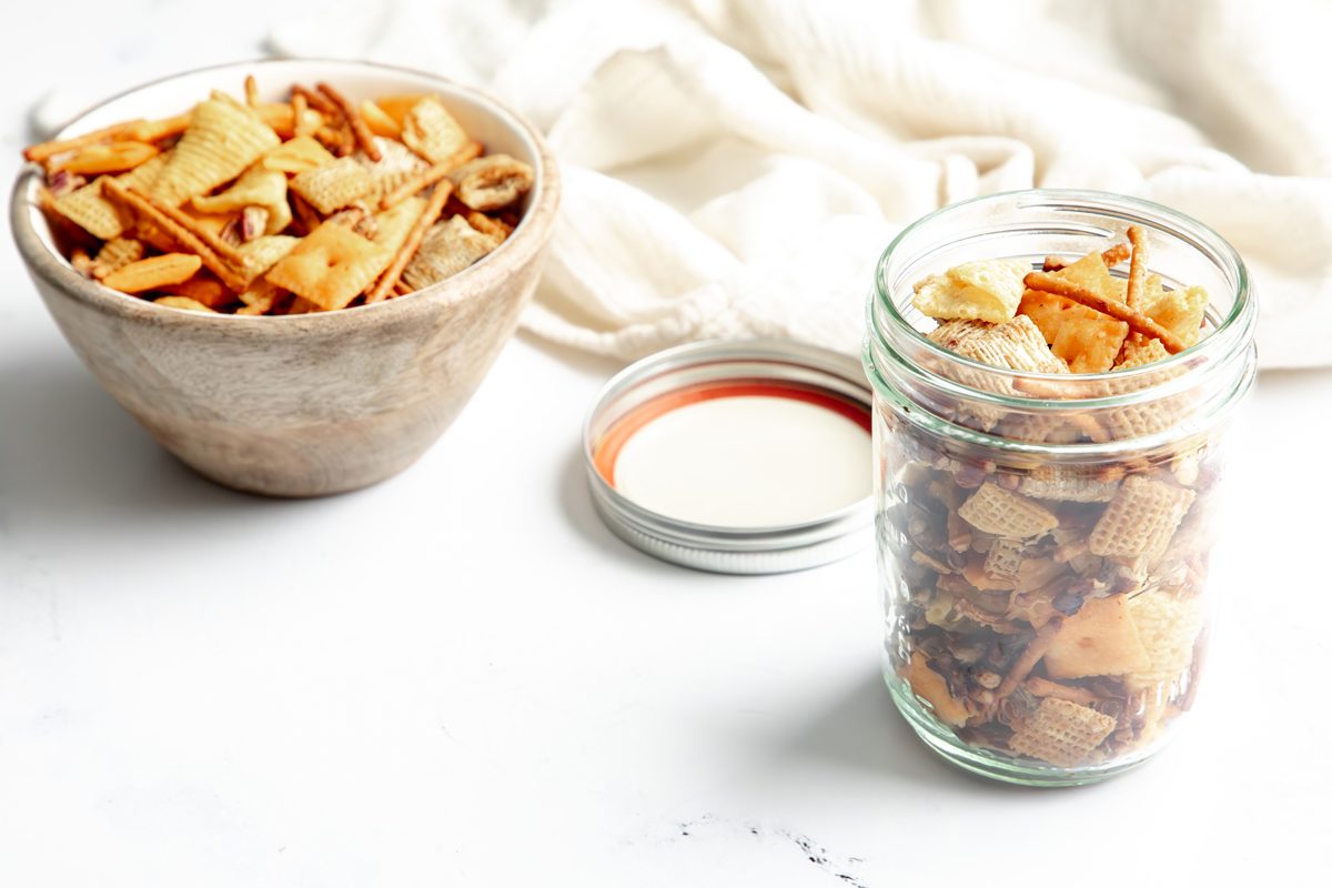 Beauty shot for Taste of Home Reindeer Chow, being served in a mason jar and bowl.
