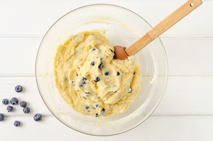 Raw dough for lemon muffins with blueberries