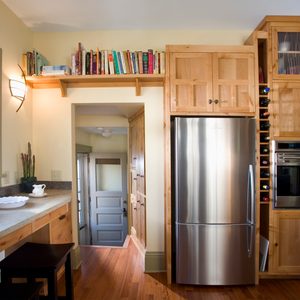 Kitchen with wooden cabinets and a stainless steel refrigerator