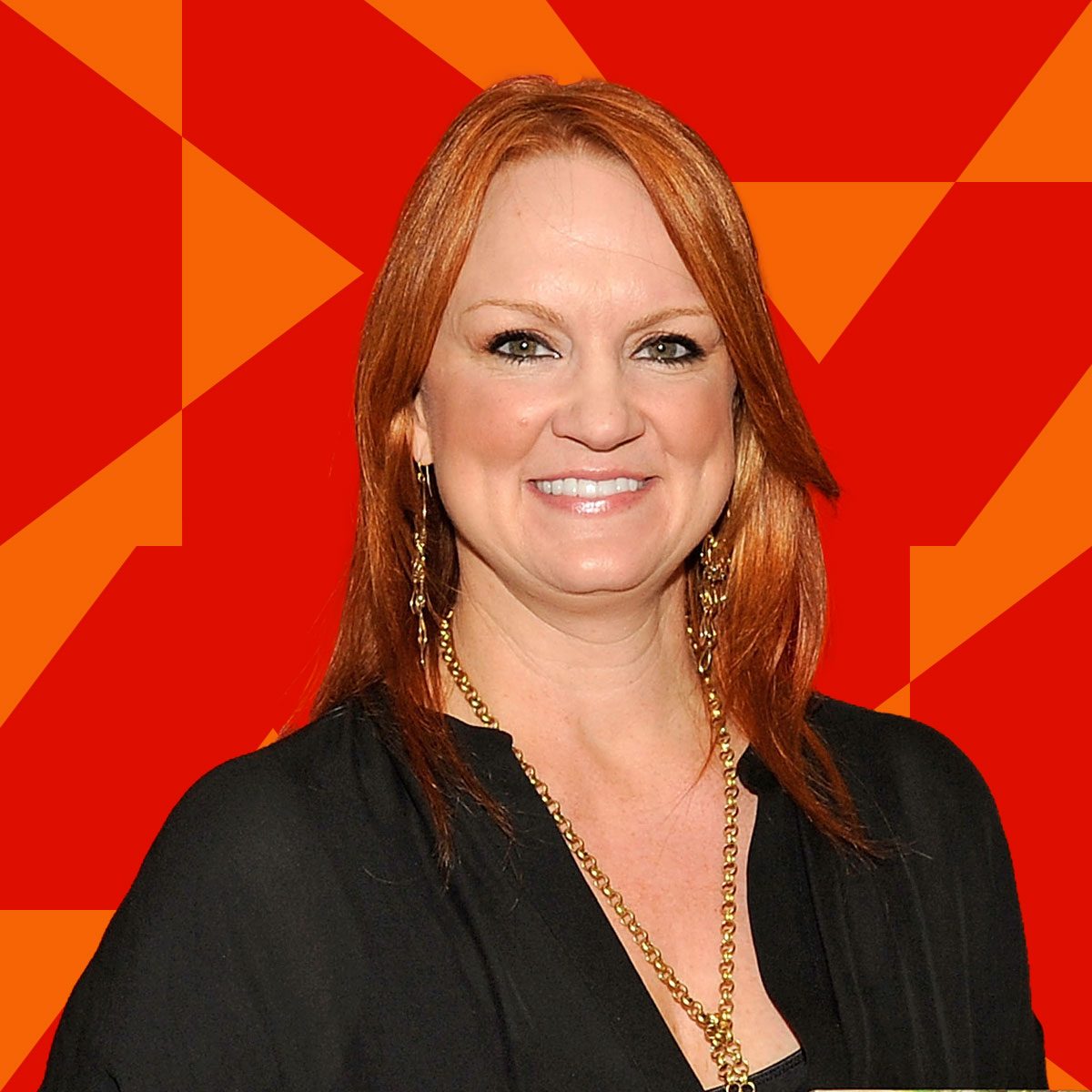 Ree Drummond on a red patterned background, smiling